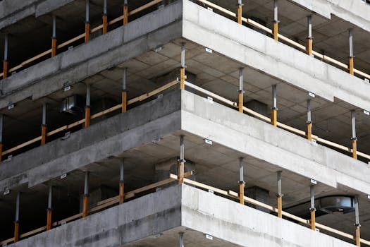 pexels-photo-7931-7931 Close-up of an unfinished multi-level concrete building with steel reinforcements.